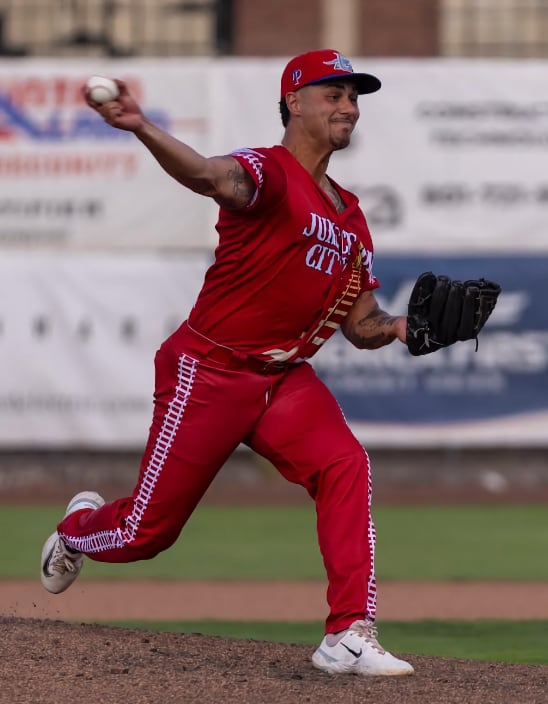 Rafi pitching in a red uniform