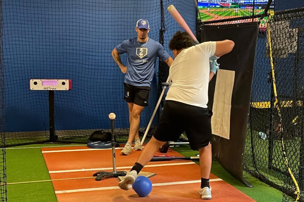 Hitter working off a tee during a private lesson at HammerZone Sports